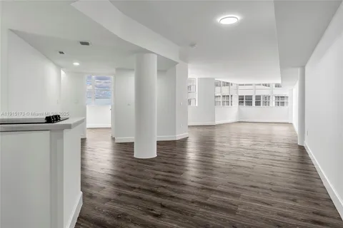 a view of a room with wooden floors