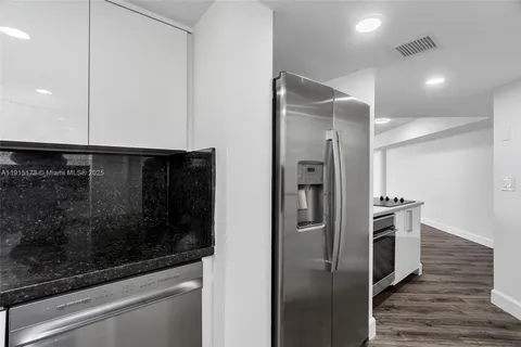 a kitchen with a refrigerator and a stove