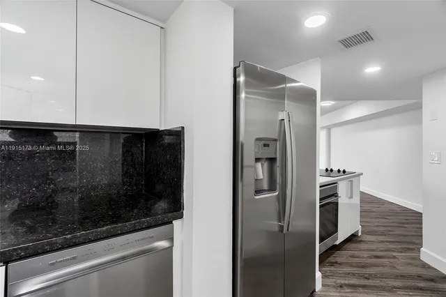 a kitchen with a refrigerator and a stove