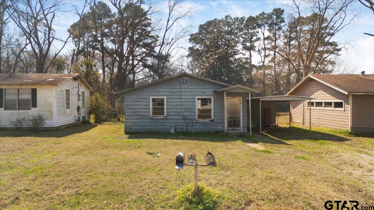 a view of a house with a yard covered in snow