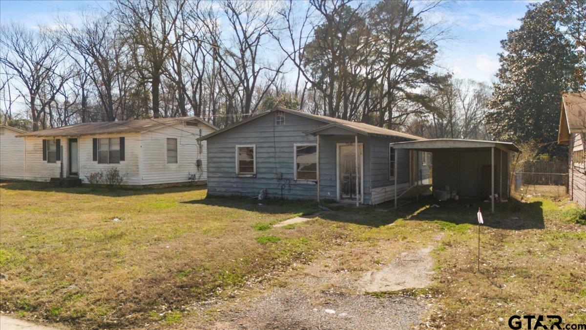 7046 Eleanor Street Tyler, TX 75708 - Photo 2 of 3 a front view of house with yard patio and fire pit