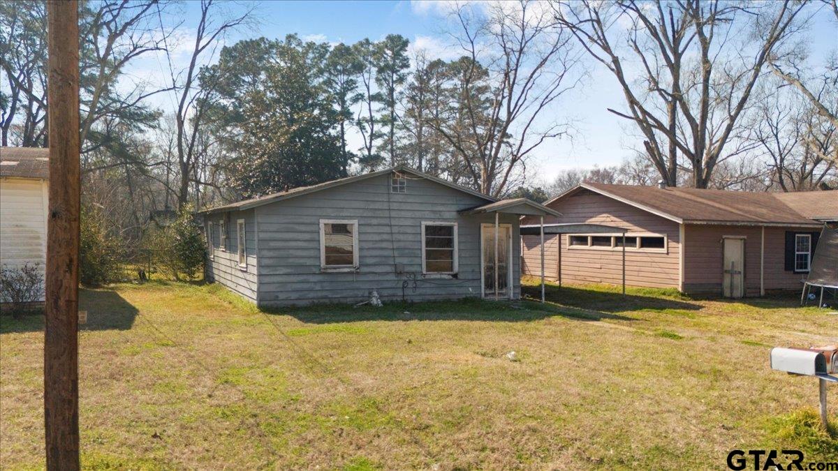 7046 Eleanor Street Tyler, TX 75708 - Photo 3 of 3 a view of a house with a yard covered with snow in front of house