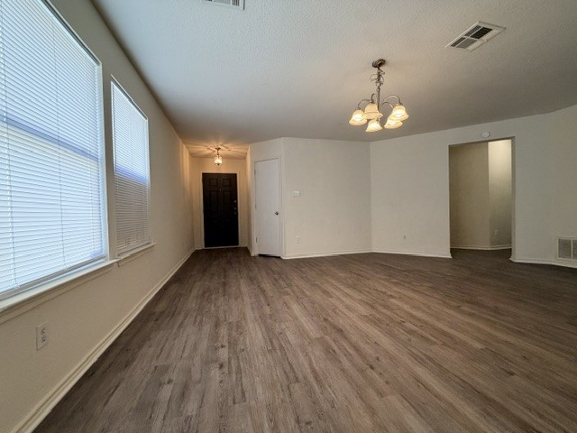 18421 Crestwind Lane Elgin, TX 78621 - Photo 5 of 34 Gleaming wood-look floors anchor this airy living space with tall windows and classic molding.