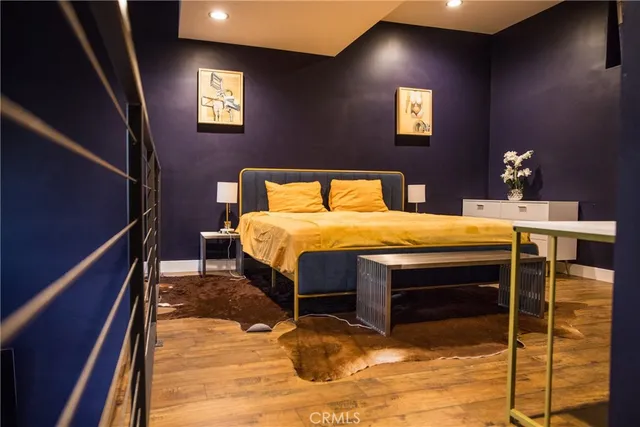 a bed sitting in a bedroom next to a window