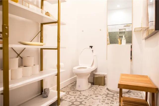 a bathroom with a toilet a sink and a window
