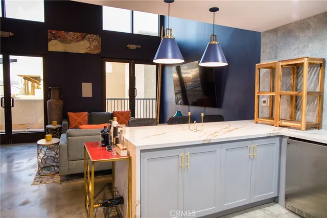 a open kitchen with a sink a stove and chairs