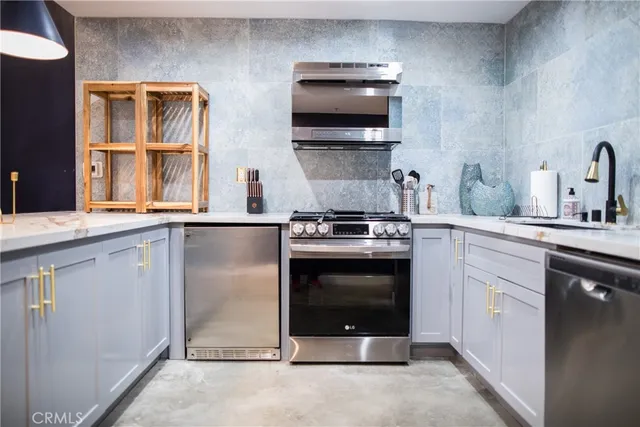 a kitchen with stainless steel appliances granite countertop a stove and a microwave