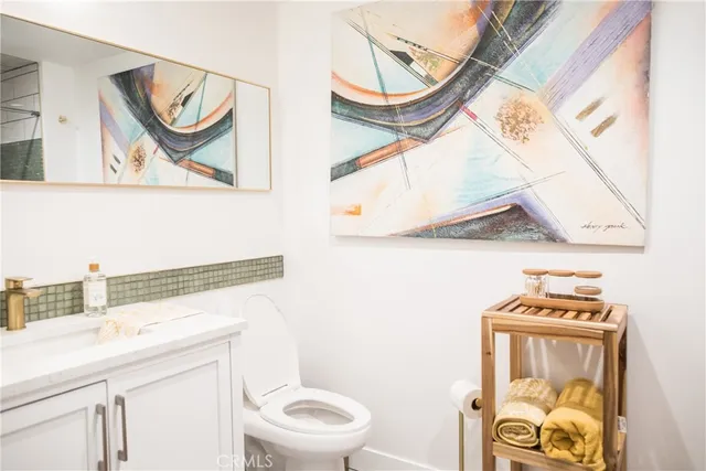 a bathroom with a toilet a sink and a mirror