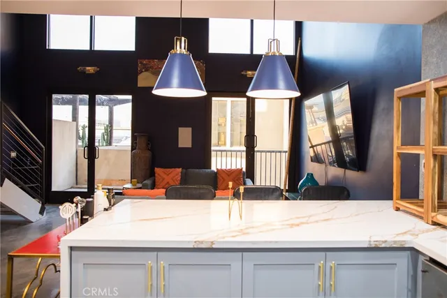 a kitchen with a sink granite counter tops and a large window