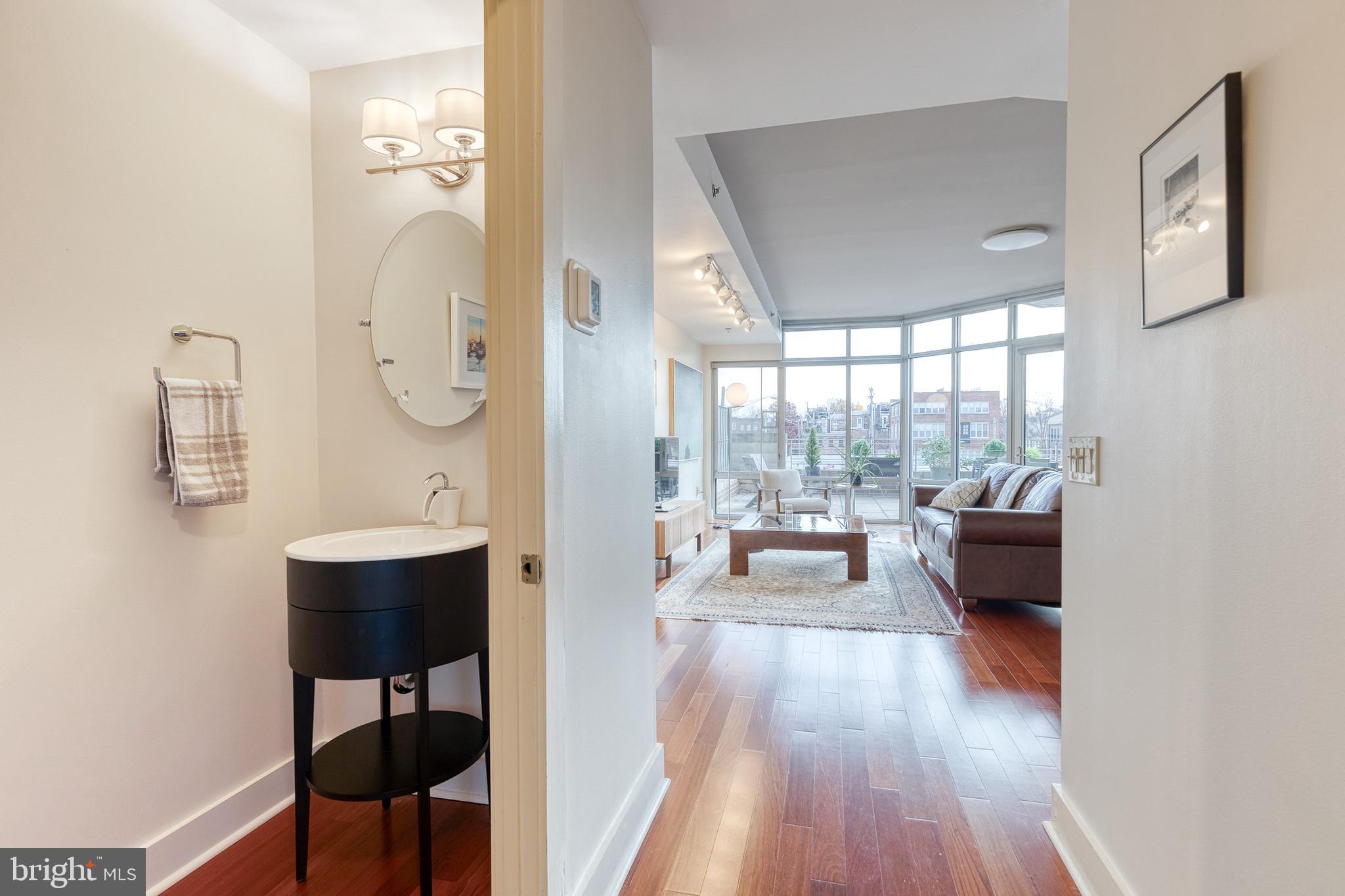 1400 Lancaster Street, Unit 305 Baltimore, MD 21231 - Photo 22 of 43 Main Level Half Bath/View into Living Room