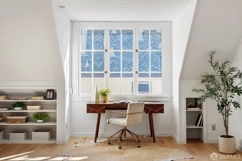 a table and chairs in a room and a window