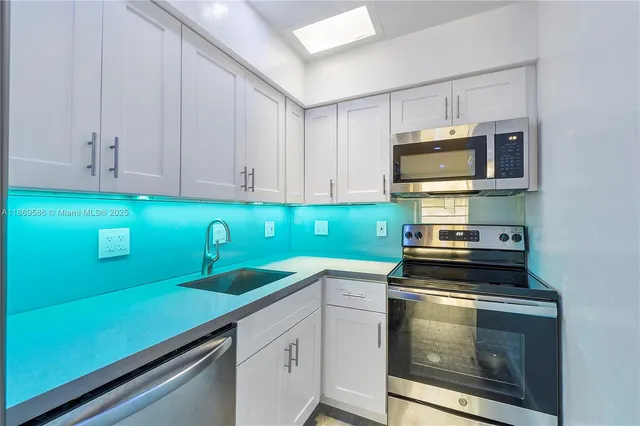a kitchen with a sink and cabinets