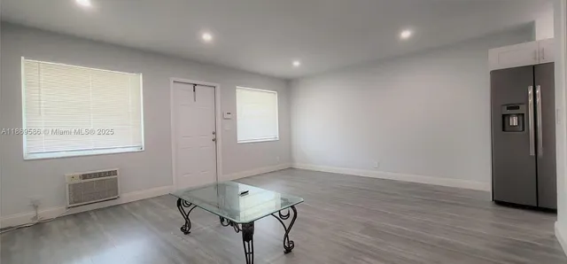 a view of room with window and wooden floor