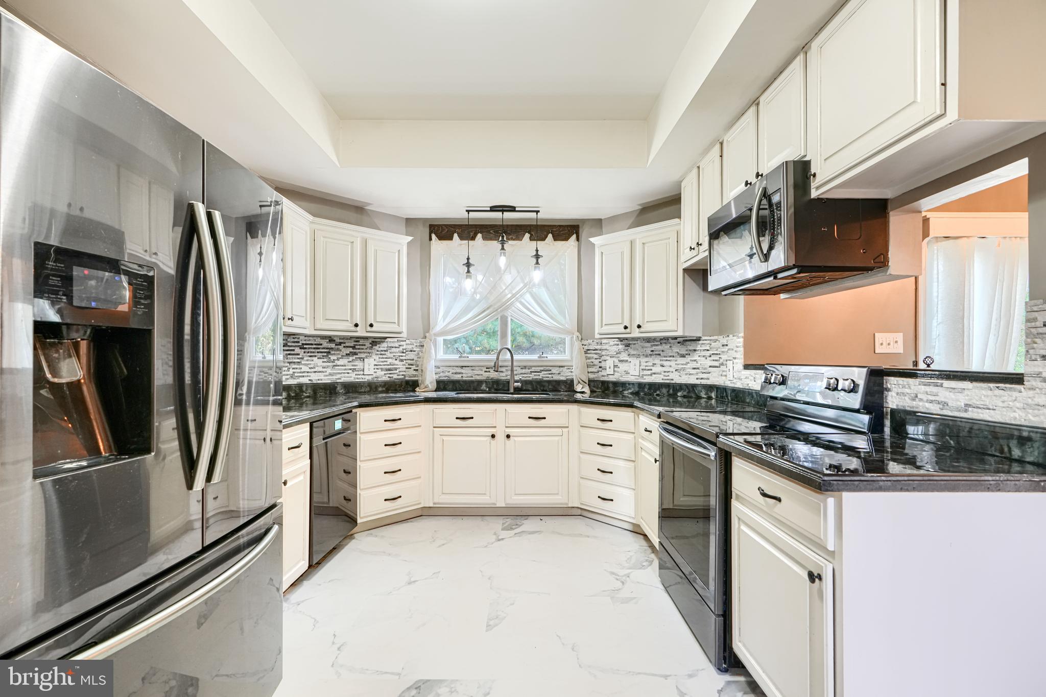 544 Elk Mills Road Elkton, MD 21921 - Photo 15 of 65 a kitchen with stainless steel appliances granite countertop a stove a sink and a refrigerator