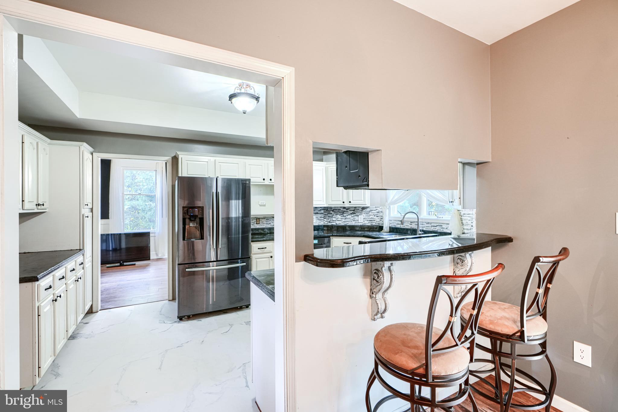 544 Elk Mills Road Elkton, MD 21921 - Photo 21 of 65 a kitchen with stainless steel appliances kitchen island granite countertop a table and chairs