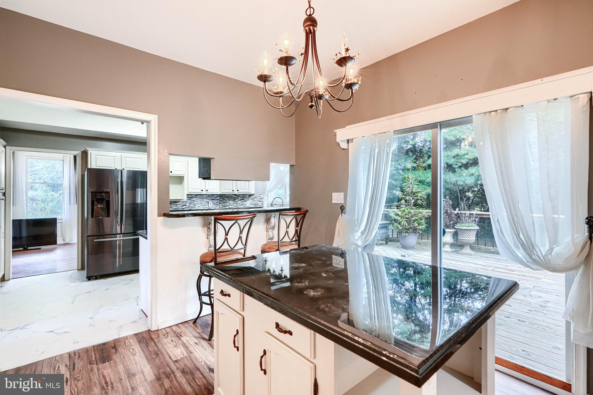 544 Elk Mills Road Elkton, MD 21921 - Photo 24 of 65 a kitchen with stainless steel appliances granite countertop a stove a refrigerator a oven with a dining table and chairs