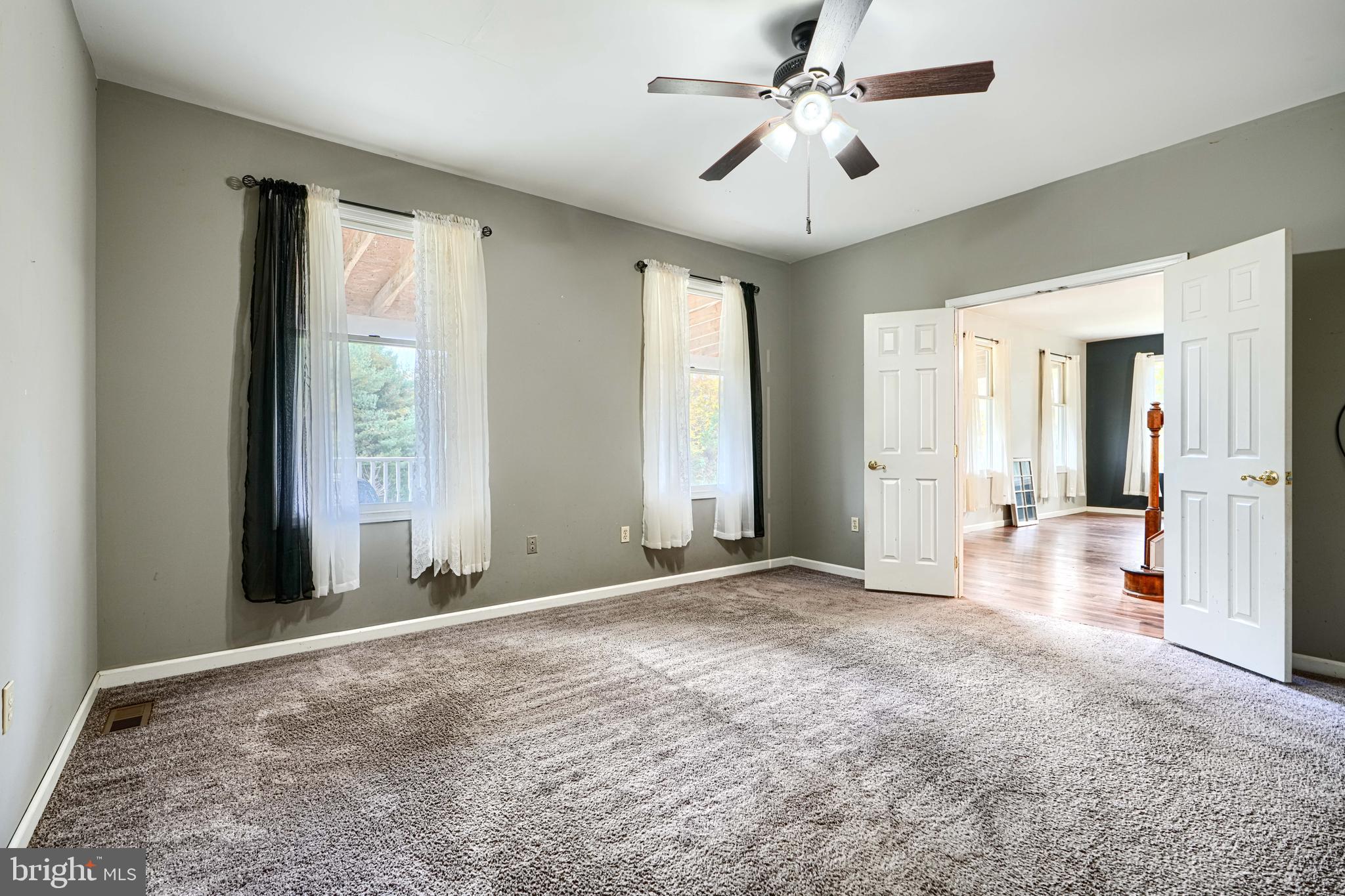 544 Elk Mills Road Elkton, MD 21921 - Photo 29 of 65 a view of a big room with windows and chandelier fan