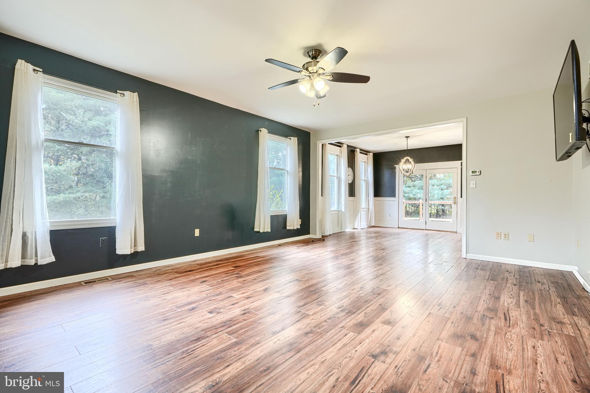 544 Elk Mills Road Elkton, MD 21921 - Photo 8 of 65 a view of an empty room with a window and wooden floor