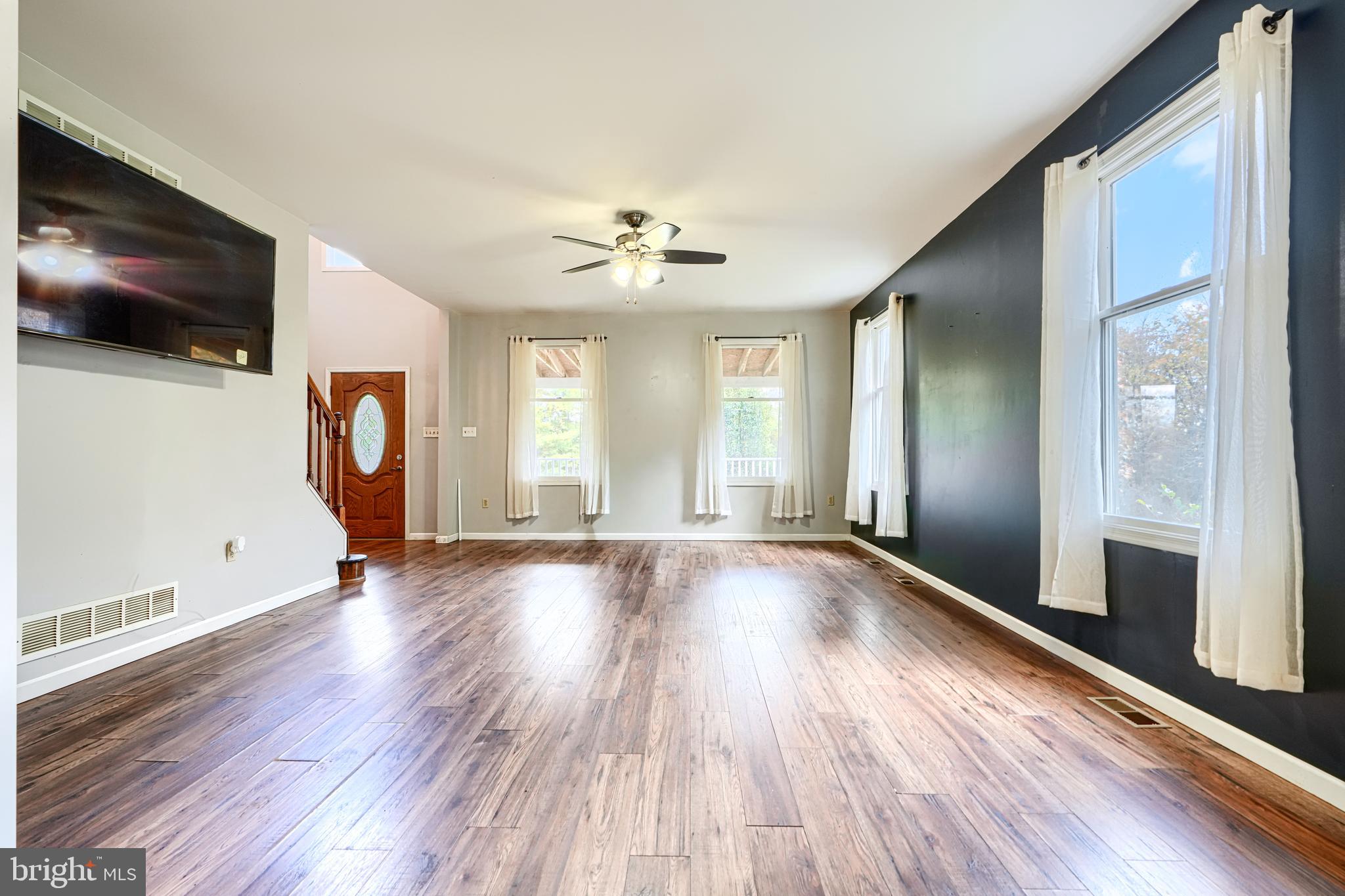 544 Elk Mills Road Elkton, MD 21921 - Photo 10 of 65 a view of an empty room with wooden floor and a window