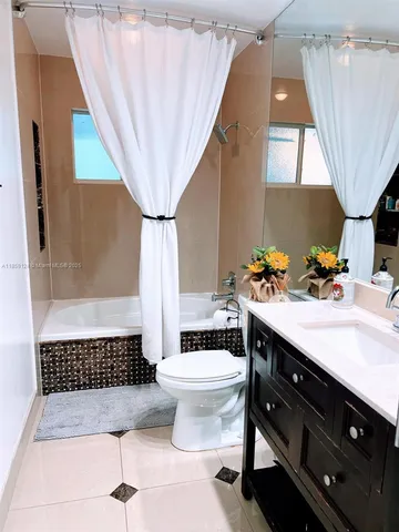 a bathroom with a sink a toilet and tub
