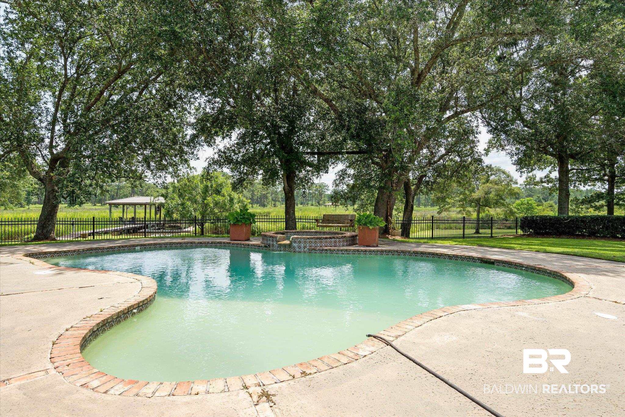 2905 Riverview Pointe Drive South Theodore, AL 36582 - Photo 26 of 44 Relaxing pool / spa featuring a fenced backyard and a patio