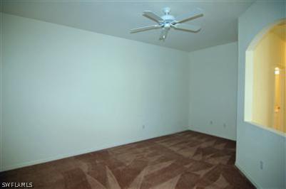 4708 Fairloop Run Lehigh Acres, FL 33973 - Photo 4 of 10 an empty room with a window and a fan