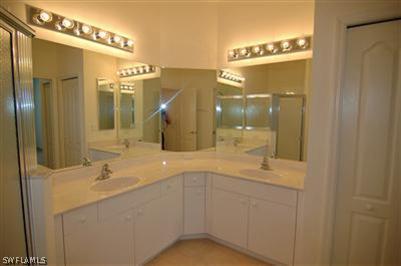 4708 Fairloop Run Lehigh Acres, FL 33973 - Photo 7 of 10 a bathroom with a sink mirror and a shower