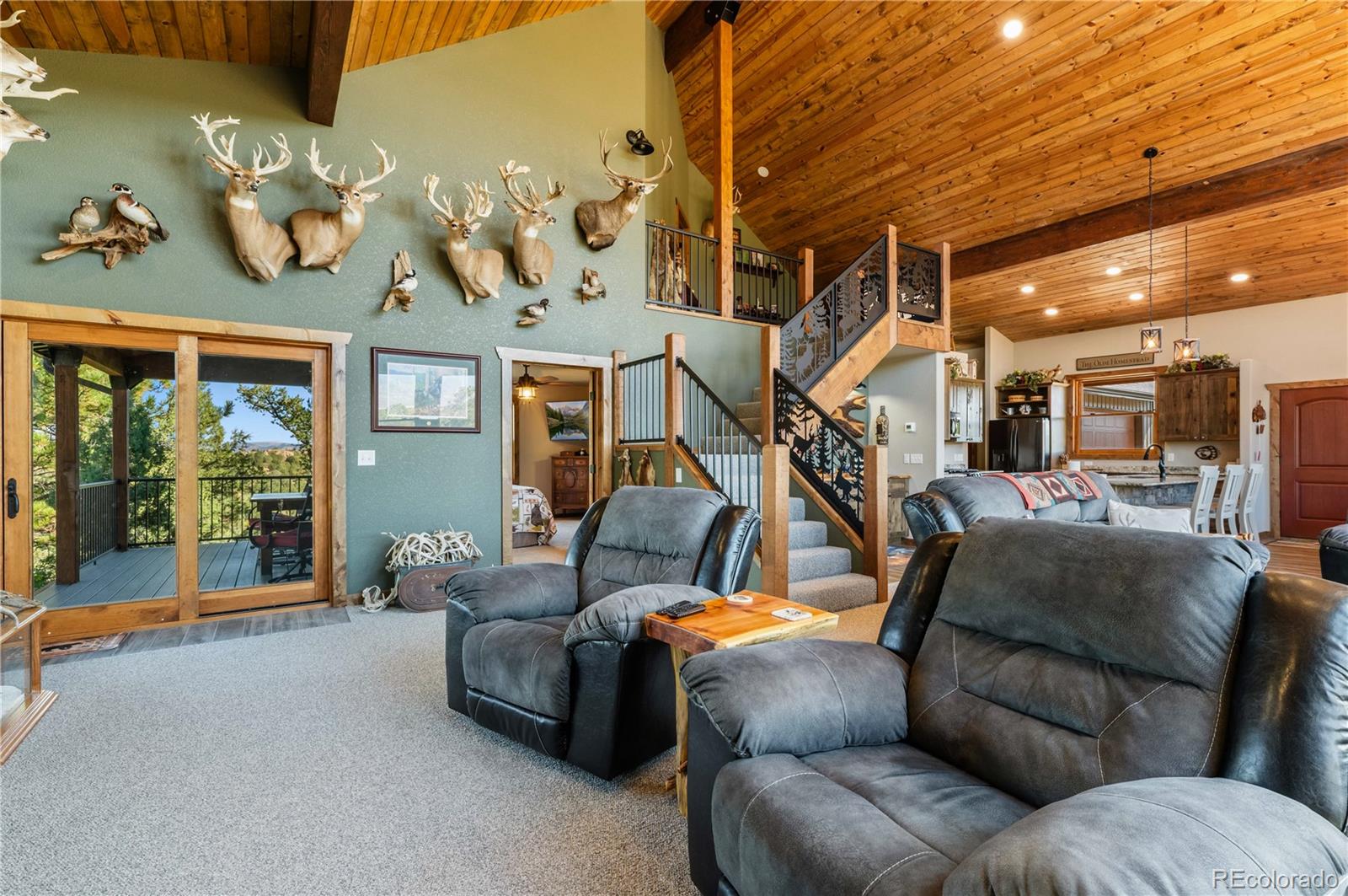 1310 Sunrise Ridge Cotopaxi, CO 81223 - Photo 24 of 50 a living room with furniture a chandelier and a floor to ceiling window