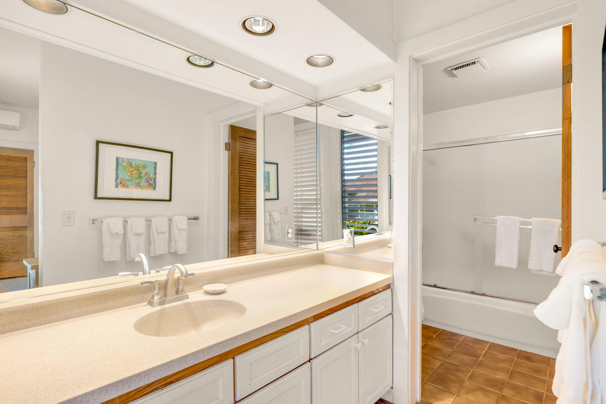 2253 Poipu Road, Unit 241 Koloa, HI 96756 - Photo 12 of 30 a bathroom with a granite countertop sink and a mirror