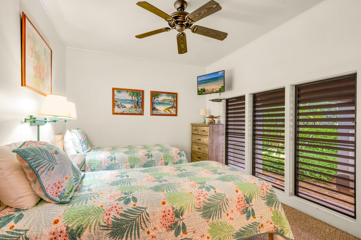 2253 Poipu Road, Unit 241 Koloa, HI 96756 - Photo 18 of 30 a bedroom with a bed and a chandelier