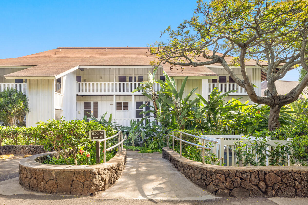 2253 Poipu Road, Unit 241 Koloa, HI 96756 - Photo 2 of 30 a view of a white house next to a yard with potted plants