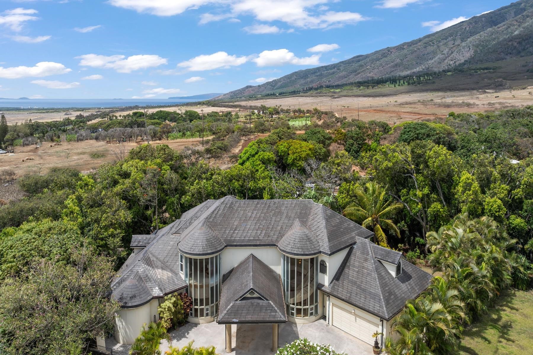 an aerial view of a house with garden space and outdoor seating