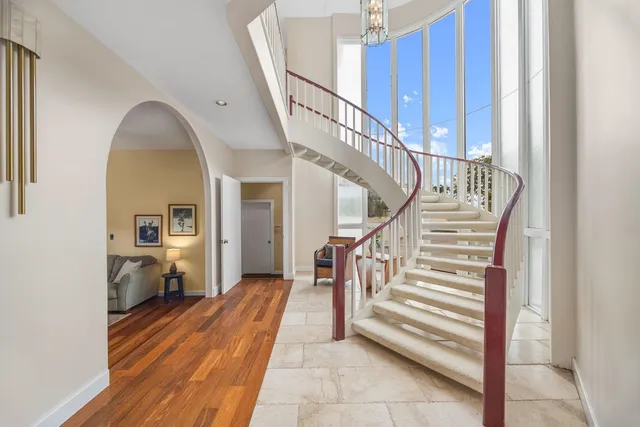 a view of a hallway to a livingroom and a window