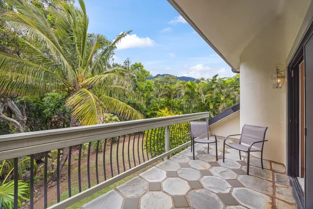 a spacious bedroom with a bed and a chandelier