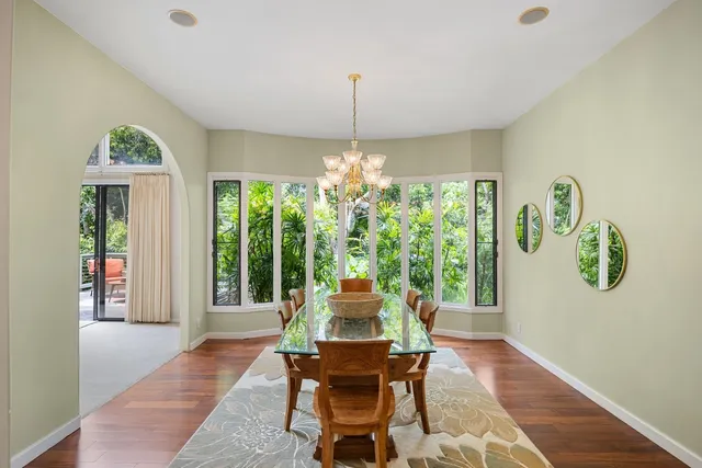 a dining room with furniture window and wooden floor