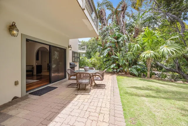 a view of swimming pool with lawn chairs and a yard