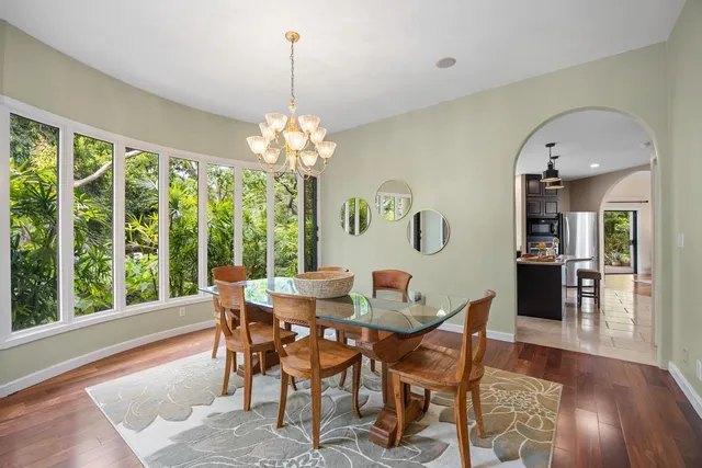 a view of a dining room with furniture wooden floor and chandelier
