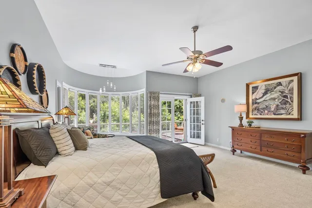 a bed room with a bed and a chandelier