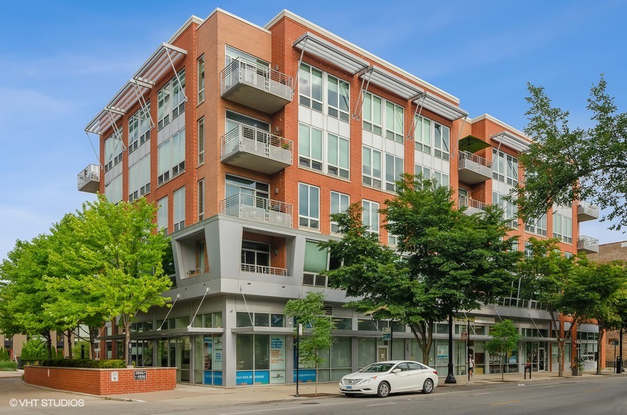 4846 North Clark Street, Unit 510 Chicago, IL 60640 - Photo 1 of 32 a front view of a building and car parked