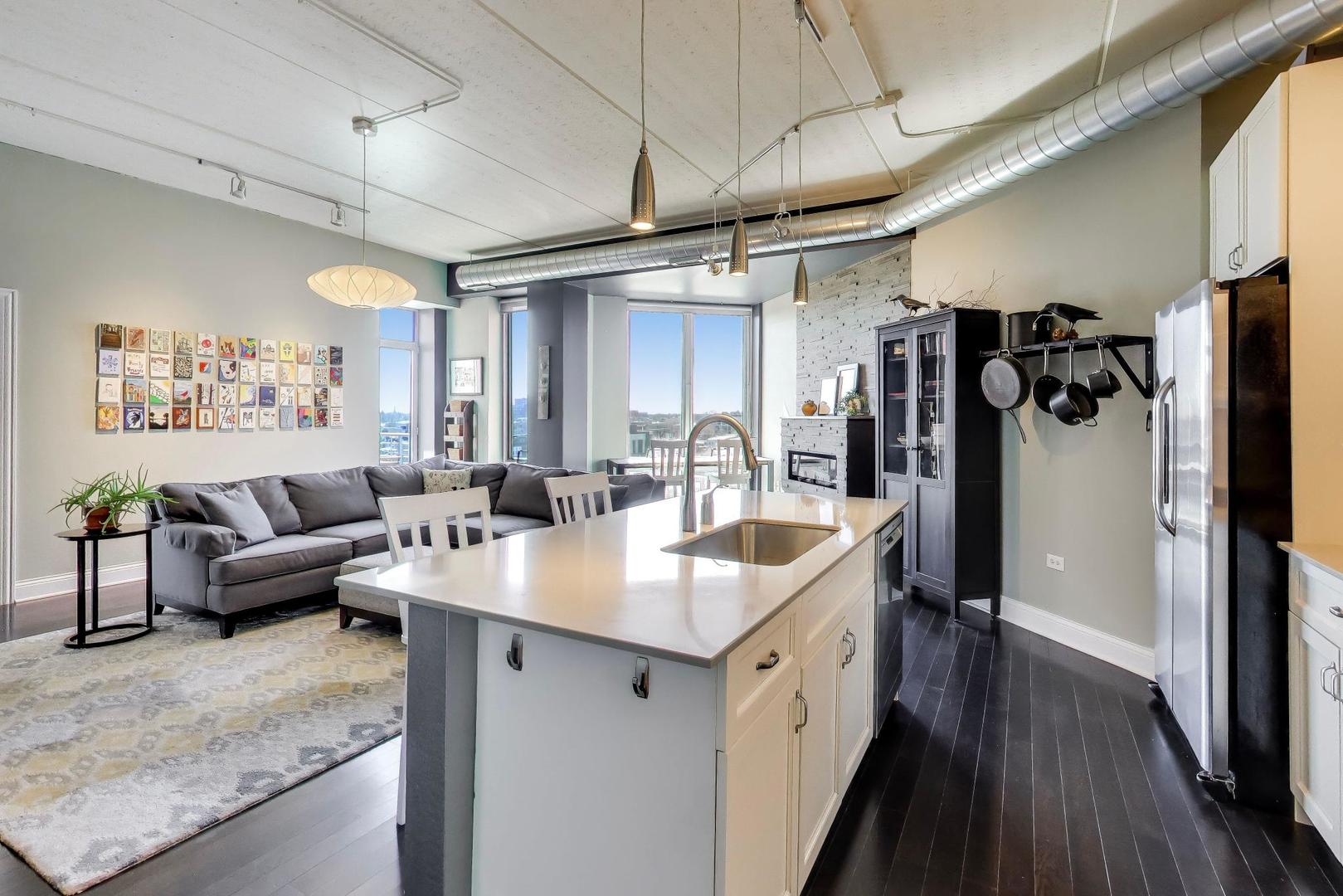 4846 North Clark Street, Unit 510 Chicago, IL 60640 - Photo 16 of 32 a living room with stainless steel appliances kitchen island granite countertop furniture and a wooden floor