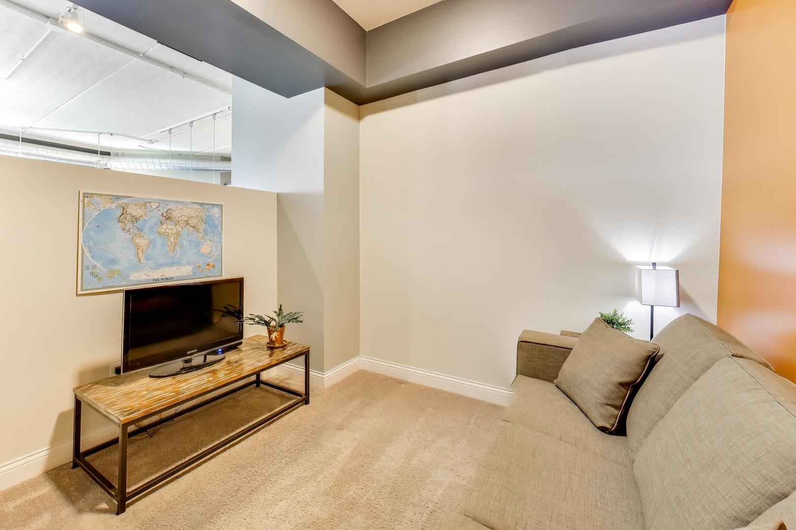 4846 North Clark Street, Unit 510 Chicago, IL 60640 - Photo 21 of 32 a bedroom with a bed and a flat screen tv