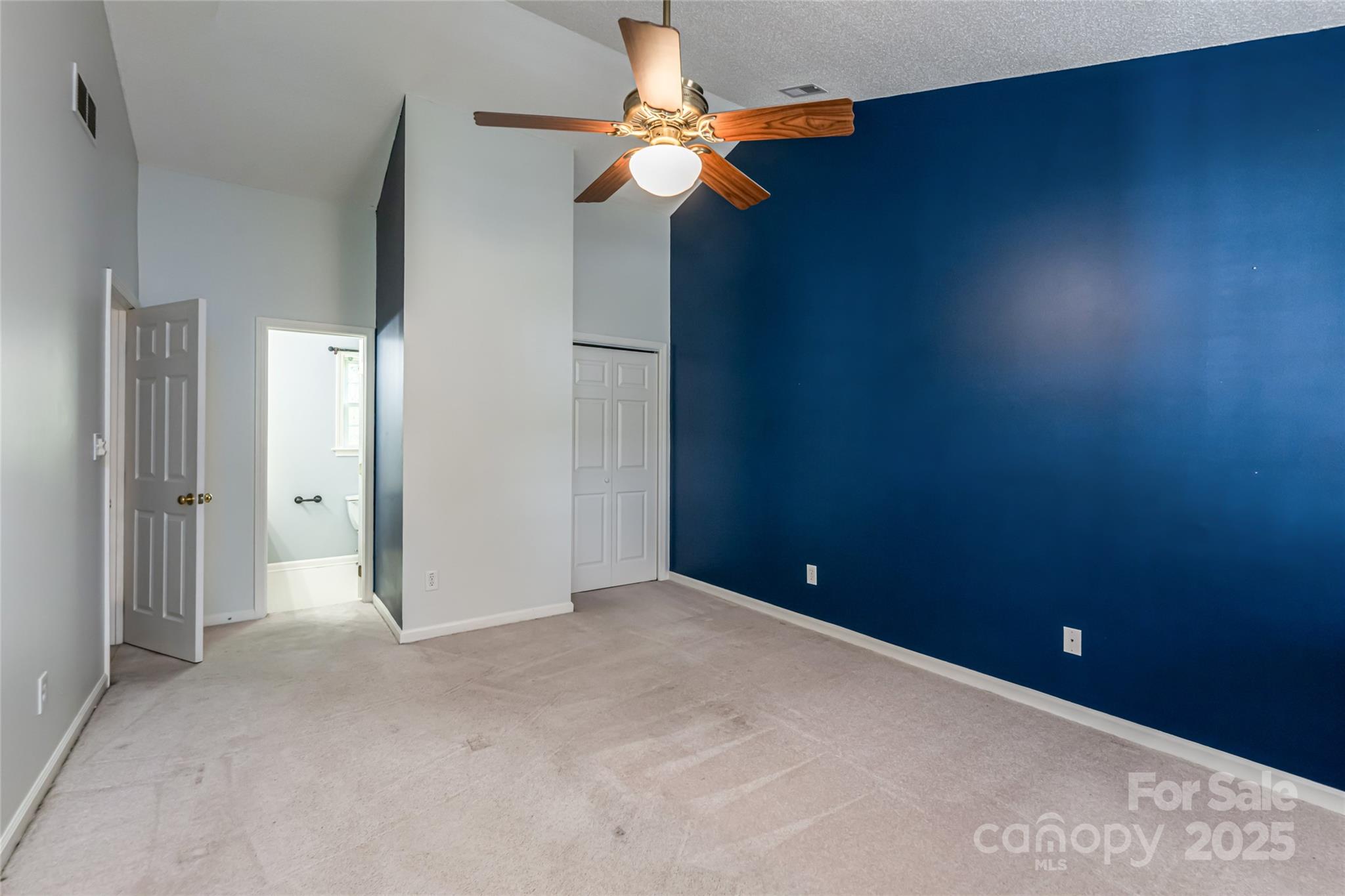 153 Rolling Meadow Road Fletcher, NC 28732 - Photo 22 of 34 an empty room with closet and a chandelier fan