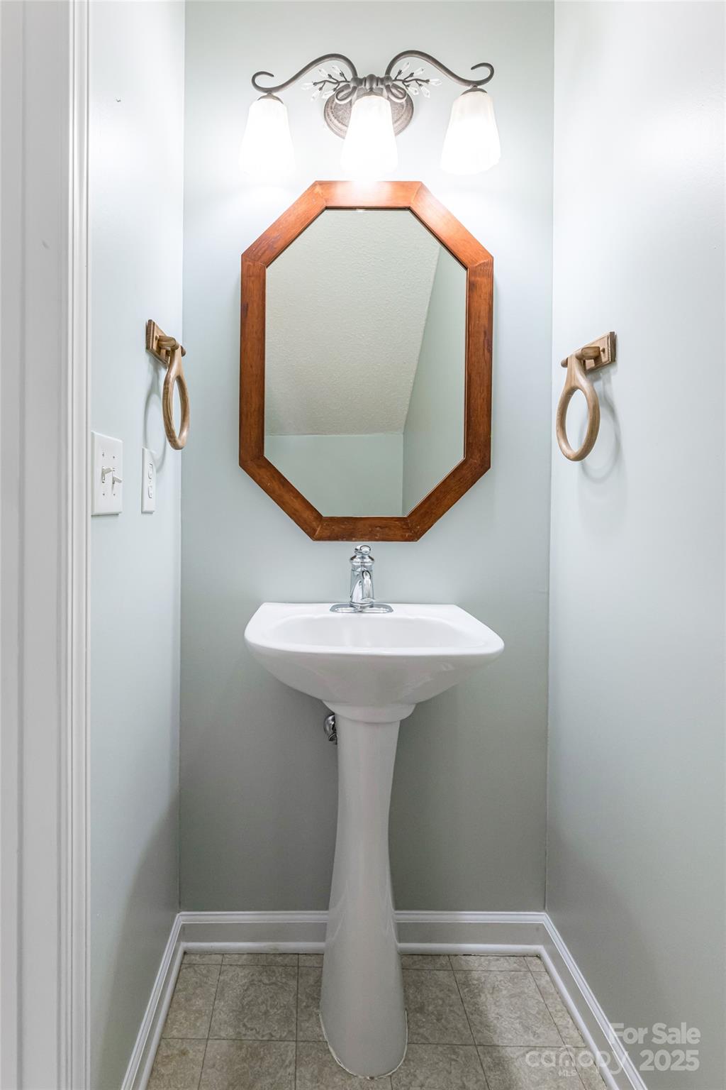153 Rolling Meadow Road Fletcher, NC 28732 - Photo 7 of 34 a bathroom with a sink and mirror
