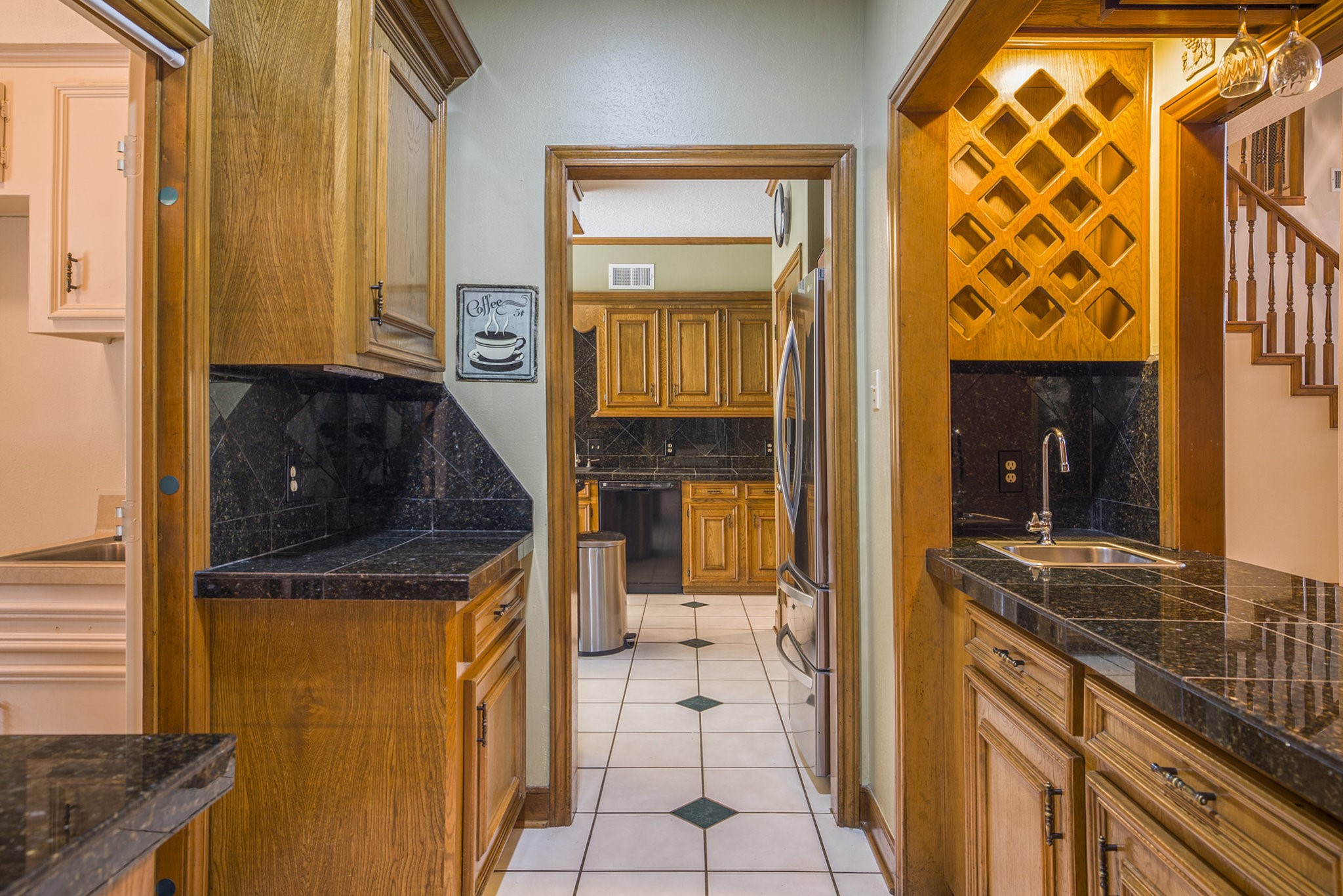 6039 Spanish Oak Way Spring, TX 77379 - Photo 12 of 38 a kitchen with a refrigerator and a stove