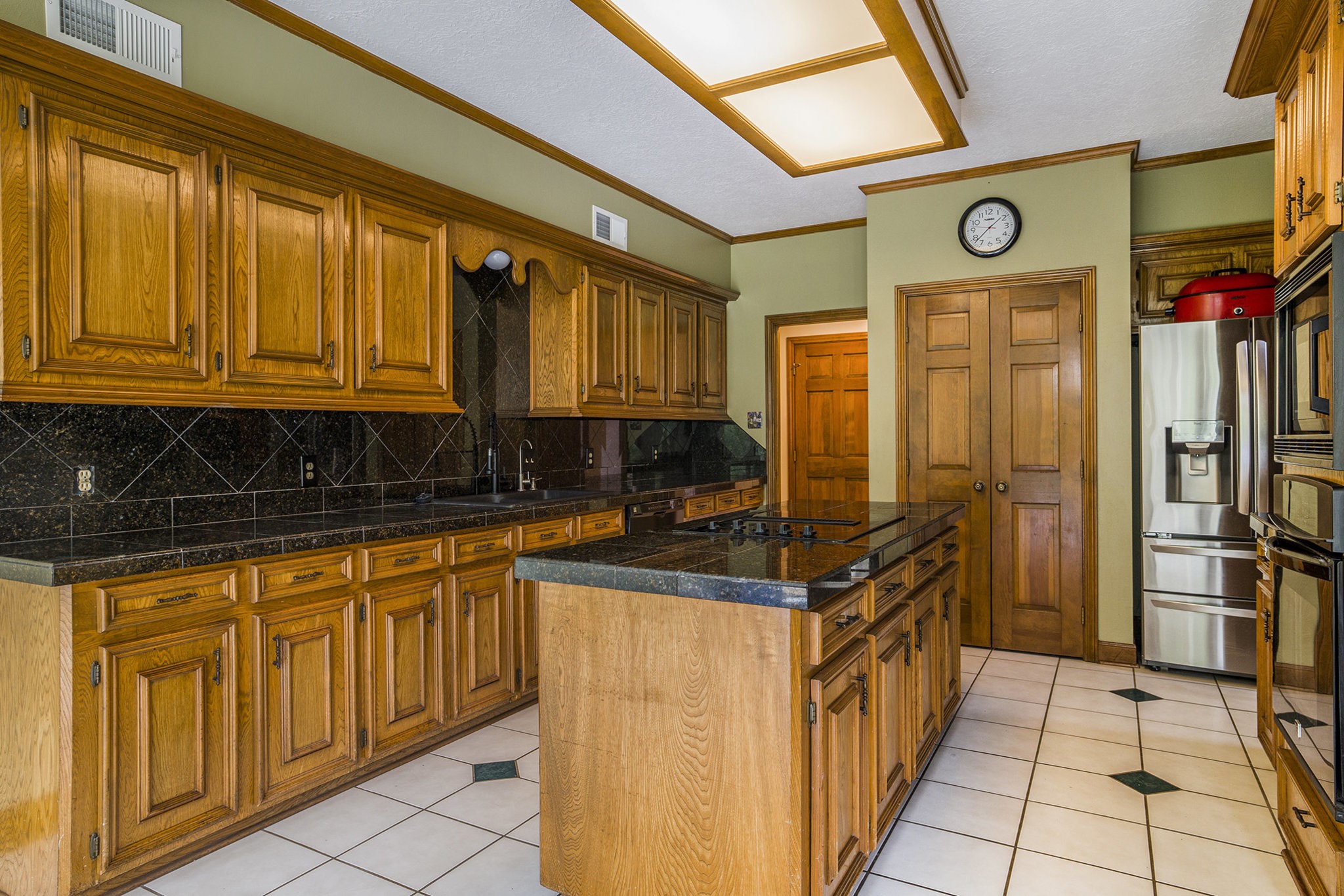 6039 Spanish Oak Way Spring, TX 77379 - Photo 13 of 38 a kitchen with stainless steel appliances granite countertop a stove and a refrigerator