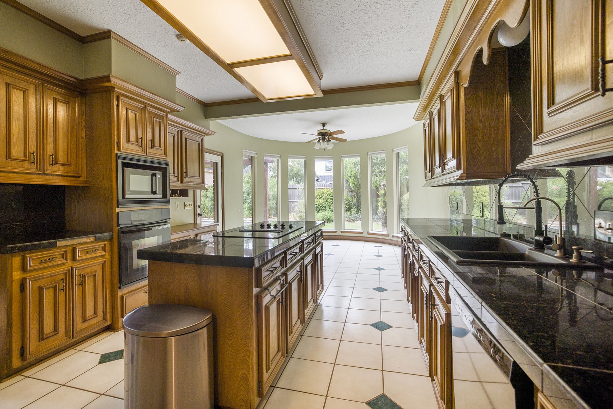 6039 Spanish Oak Way Spring, TX 77379 - Photo 15 of 38 a kitchen with stainless steel appliances granite countertop a sink stove and cabinets
