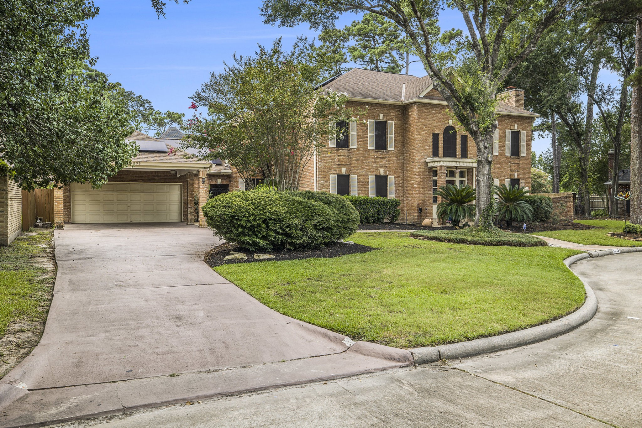 6039 Spanish Oak Way Spring, TX 77379 - Photo 2 of 38 a view of a white house with a swimming pool and a yard
