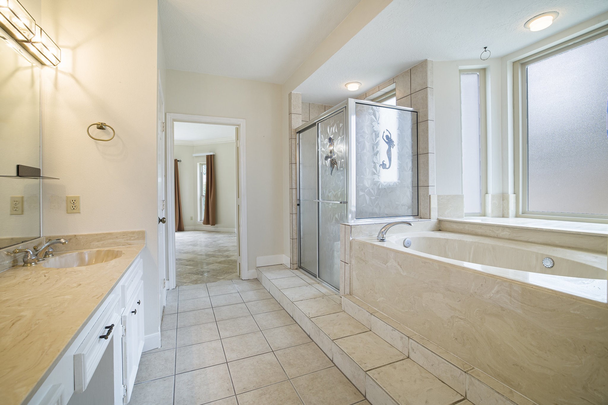 6039 Spanish Oak Way Spring, TX 77379 - Photo 24 of 38 a spacious bathroom with a tub shower sink and mirror