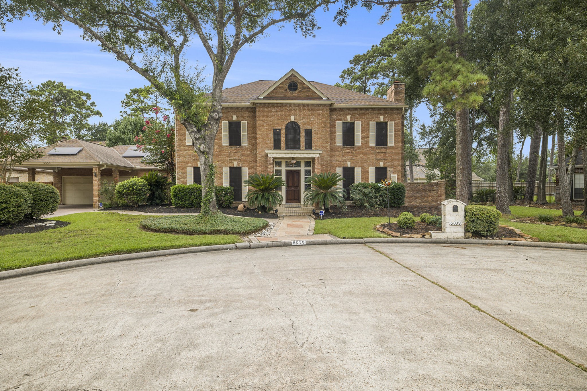 6039 Spanish Oak Way Spring, TX 77379 - Photo 3 of 38 a front view of a house with a yard and potted plants