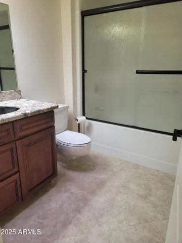 a bathroom with a granite countertop sink double and mirror